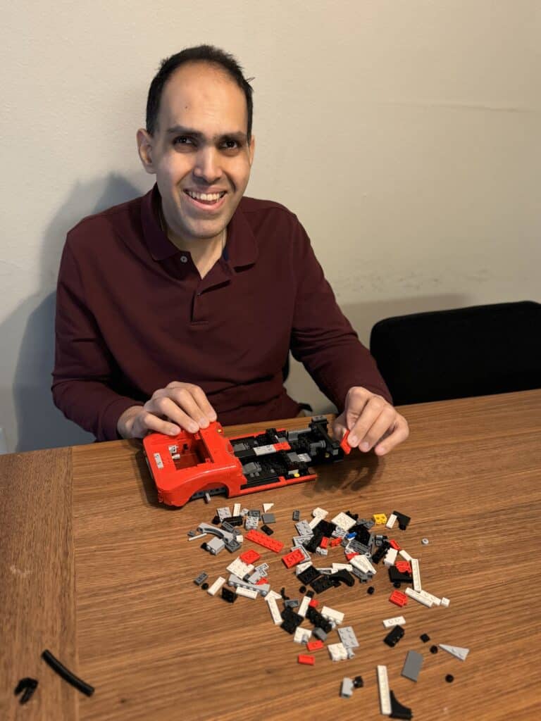 Saqib, a man wearing maroon t-shirt built lego Chevrolet Corvette 1971.