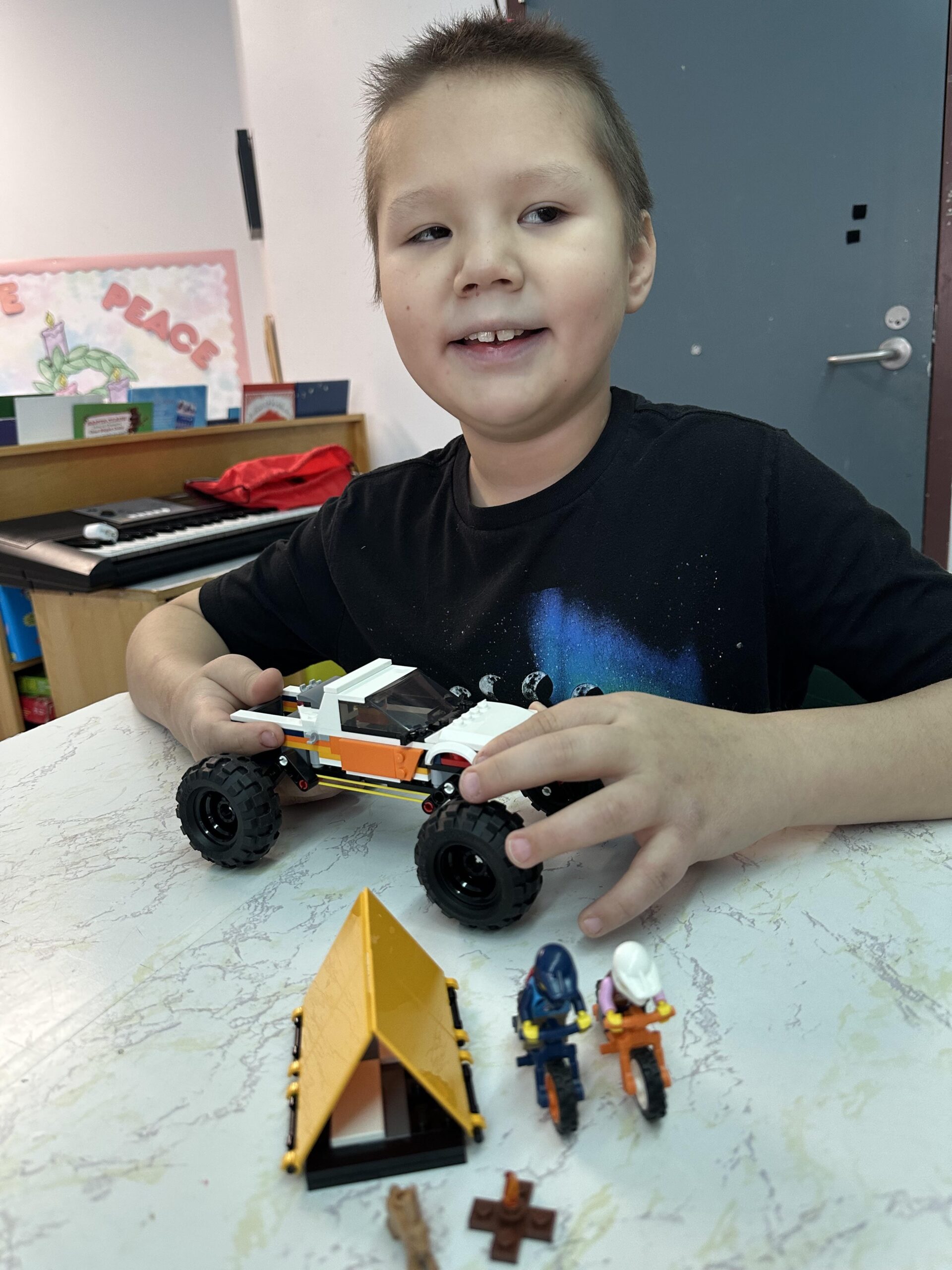 Picture of young blind child with completed LEGO buildJonathan N.