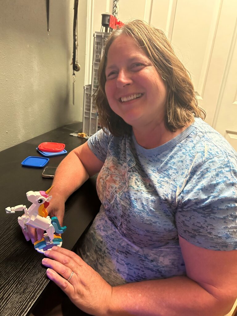 Picture of woman holding a Magical Unicorn LEGO build